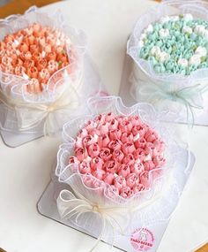 three baskets filled with different colored candies on top of a table