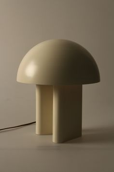 the mushroom lamp is white and has a cord attached to it