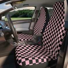 the interior of a car with pink and black checkerboard seat covers on it