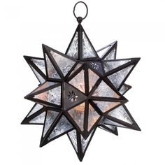 a moravian star hanging from the ceiling with two lights on each side and one light in the