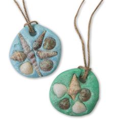 two ceramic ornaments with seashells on them