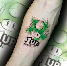 a person with a green tattoo on their arm that says tup in black ink