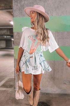 Looking for a cute country concert outfit for summer? Try this oversized graphic tee as a dress with cowboy boots and a pink hat! This trendy western graphic tee is the perfect addition to any outdoor country concert outfit, Nashville vacation outfit, Nashville bachelorette outfit or girly country outfit! Shop cute western graphic tees today at Sassy Queen, your one stop shop for trendy summer outfits and cute southern summer outfits for women! Western Graphic Tees Outfit, Southern Summer Outfits, Casual Country Concert Outfit, Nashville Bachelorette Outfit, Outdoor Country Concert Outfit, Concert Outfit Nashville, Nashville Summer Outfits, Summer Country Concert Outfit, Dresses With Cowboy Boots