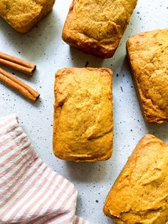 several muffins and cinnamon sticks on a table