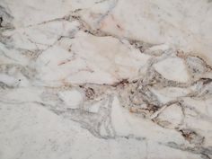 the marble is white and grey with brown spots