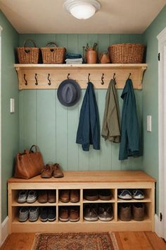 a wooden bench sitting under a light next to a coat rack filled with hats and shoes