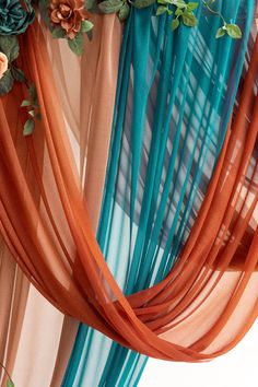 an orange and blue drape with flowers on it