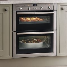 two ovens side by side with food cooking in them