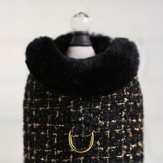 a black and gold coat with a ring on it