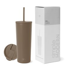 a brown tumbler cup next to a cardboard box with the lid open and straw in it