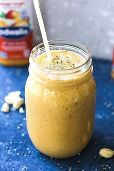 a jar filled with peanut butter and topped with a straw