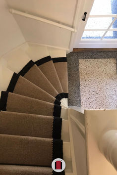 an overhead view of a stair case in a house with carpeted floors and white walls