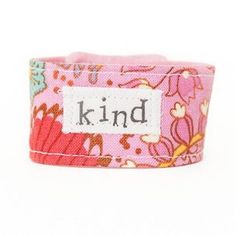 This "KIND" Blessing Band© acts as a tangible reminder of your love for a special child in your life. The secret love note on the interior provides a special connection throughout the day. The pink floral bracelet features the word "kind" on the front. The secret message on the interior reads "Be kind, be brave and know that you are loved!". The bracelet closes with a sturdy snap.The cuff comes in two sizes, kid (6"-7" x 1") and toddler (5"-6" x1") . Spot-cleaning or dry-cleaning recommended. Customized Pink Bracelet Wristband, Whimsical Personalized Pink Bracelet, Playful Handmade Pink Wristband, Pink Bohemian Heart-shaped Bracelets, Pink Heart-shaped Bohemian Bracelets, Secret Message Bracelet, Fabric Cuff Bracelet, Bracelet Quotes, Message Bracelet