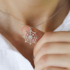 This Silver Spiderweb Necklace (Silver Spiderweb Necklace, Dainty Funky Silk Spider Pendant, Cobweb Halloween Costume Accessory, Trick or Treat Jewelry Gifts for Her Kids) is a perfect gift. Our jewelry are water and tarnish-resistant, nickel-free, and available 14K Gold plating on 925 Sterling Silver. They make a great gift for special events and days (e.g. birthdays, anniversaries, holidays). Materials: 925K Sterling Silver Style: Minimalist  Charm Size WXH: 20x20mm Chain style: Cable Chain le Halloween Themed Silver Necklaces, Silver Themed Necklace For Halloween, Themed Silver Necklaces For Halloween, Silver Themed Halloween Necklace, Personalized Silver Necklace For Halloween, Spiderweb Necklace, Silk Spider, Spider Silk, Spider Pendant