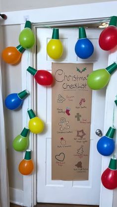 a door decorated with christmas lights and decorations for the holiday season is shown in front of a bulletin board