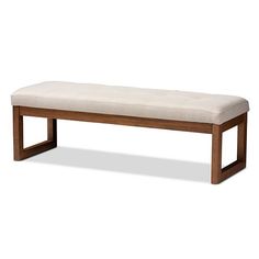 a bench that is made out of wood and upholstered with a white cushion