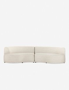 a white couch sitting on top of a white floor