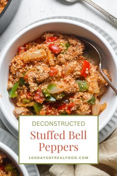 a bowl filled with stuffed bell peppers on top of a white plate next to a spoon