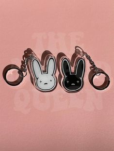 three keychains with cartoon characters on them, one is black and the other is white