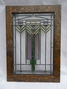 an art deco stained glass window with wood frame