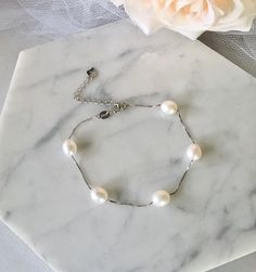 Classy and timeless, this glowing pearl bracelet can complete the most sophisticated of bridal looks. Excellent quality cultured pearls (10-11mm teardrop) are paired with sterling silver (marked 925) for a simple, but very elegant look. Length: 7.5" (approx. 19cm) with a 2" (approx. 5cm) extension chain for comfortable sizing. Closure is a secure spring ring clasp. Available in three beautiful colors: White, Blush and Mauve. To choose your desired color select from the dropdown menu. This beauti Adjustable Pearl Bracelet With Pearl Pendant For Wedding, Elegant Pearl Pendant Bracelet, Pearl White Bracelets With Pearl Pendant For Weddings, White Pearl Pendant Bracelet For Wedding, Formal White Gold Pearl Bracelets, Elegant Hypoallergenic Necklace For Formal Occasions, Formal Pearl Bracelet With Round Beads And Pendant, Elegant Adjustable Bracelet With Pearl Pendant, Elegant Bracelet With Pearl Pendant As Gift