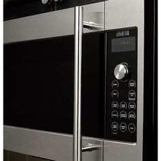 a stainless steel microwave oven with the door open and knobs on it's side