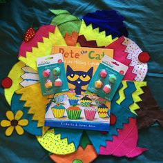 the book pete the cat is sitting on top of some cupcakes