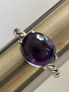 David Yurman  Gem Classic Collection  Previously  Used  Estimated retail $495  Specifications 12mmx10mm Cabochon Amethyst  Metal: cable 925 Sterling Silver 2mm++ band  Signature : inside the band  Hallmark: 925 Guarantee: 100% Condition: Very Good Jewellers Bench, Cabochon Ring, Purple Band, Classic Collection, David Yurman, Ring Size 7, Solitaire Ring, Sterling Silber, Accessories Design