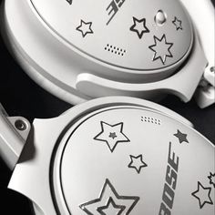 two white headphones with stars on them