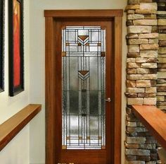 a wooden door sitting next to a window in a room filled with stone and wood