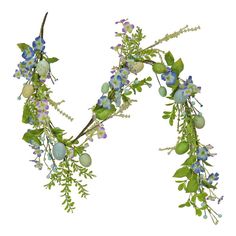 an arrangement of blue flowers and greenery on a white background with clippings