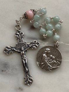 "This is a beautiful, wire-wrapped, heirloom single decade rosary! The rosary is handmade with sterling silver wire, chain and bead caps. The medals and crucifix are all sterling silver.  The beads are 6mm jade and 8mm pink opal.  \"Cantantibus organis caecilia decantabat dicens fiat cor meum immaculatum ut non confundar\" \"With instruments playing Cecilia sang saying: May my heart be made immaculate that I may not be confounded\"" Sterling Silver Spiritual Rosary With Crucifix, Spiritual Sterling Silver Crucifix Rosary, Handmade Spiritual Silver Rosary, Handmade Silver Rosary With Crucifix, Spiritual Silver Beads Rosary Gift, Spiritual Wire Wrapped Rosary As Gift, Spiritual Gift Wire Wrapped Rosary, Spiritual Sterling Silver Rosary With 8mm Beads, Silver Spiritual Rosary For Healing