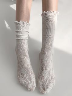 Elevate your outfit with these charming floral pattern lace socks. Available in classic black or white, these delicate socks add a touch of elegance to any look. The intricate floral design makes these socks a perfect choice for adding a hint of femininity to your ensemble.   Please note that this product includes one pair of socks only.