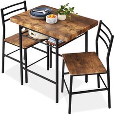 a wooden table with two chairs and a bowl of fruit on the table next to it