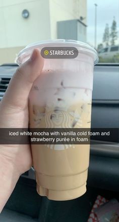 someone holding up a starbucks drink in their hand with the caption starbucks iced white mocha with vanilla cold foam and strawberry puree in foam