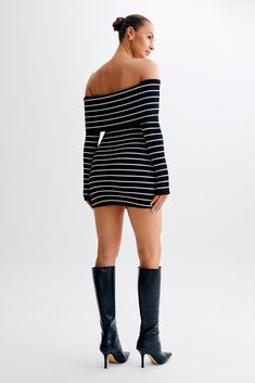 Stripes over checks. Indulge in the allure of the DOMINICA Off Shoulder Knit Mini Dress, a captivating blend of sophistication and allure. Designed to accentuate your curves, this dress features an off-the-shoulder neckline that exudes effortless charm, with an overlay gracefully draping over the arms for a touch of elegance. The long sleeves offer a sleek silhouette, while the bodycon fit flatters your figure with undeniable allure. Crafted from ribbed fabrication, this dress showcases both com Chic Off-shoulder Bodycon Dress, Black Fall Dress With Straight Neckline, Black Dress With Straight Neckline For Fall, Fall Black Dress With Straight Neckline, Chic Off-shoulder Midi Dress For Fall, Chic Fitted Off Shoulder Dress For Fall, Chic Off-shoulder Bodycon Mini Dress, Chic Fitted Off Shoulder Dress With Boat Neck, Bodycon Off-shoulder Sweater Dress