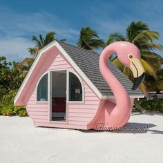 a pink house shaped like a flamingo on the beach