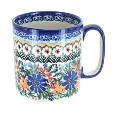 a blue and white coffee cup with flowers on the inside, sitting in front of a white background