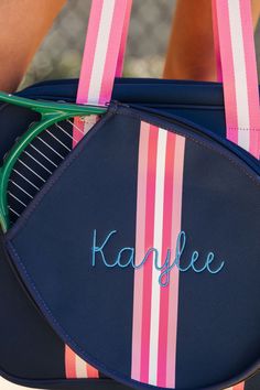 Serve up your style on the court with our Striped Monogram Tennis Bag! This personalized bag is embroidered with your favorite colors, making it a great gift for any tennis lover. With plenty of space for all your gear, it's the perfect way to bring both fashion and functionality to your game (love, set, match!). Bag Details: 15.5 x 13 x 6 inches Neoprene Material Nylon interior lining with inside zipper pocket Detachable front paddle pocket Detachable crossbody strap with adjustable lengths 2 Interior side pockets to hold water bottles Sporty Travel Bag With Embroidered Logo, Navy Rectangular Sporty Bag, Navy Sporty Rectangular Bag, Sporty Navy Rectangular Bag, Vacation Games, Balloon Hat, Striped Bag, Stadium Bag, Tennis Bags