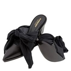 Burberry Ladies Heels. SKU: 8029974. Color: Black. Burberry Black Synthetic Tillington Ankle-wrap Mules. A pair of point-toe mules topped with a wraparound strap that ties at the ankle, leather sole and a block heel with 70mm/2.7inch height. Please visit the brand website for sizing information. Closed Toe Mules With Wrapped Heel For Fall, Fall Season Closed Toe Mules With Wrapped Heel, Black Sandals With Wrapped Heel And Pointed Toe, Black Pointed Toe Mules With Heel Loop, Chic Flat Heel Mules With Wrapped Heel, Chic Mules With Wrapped Flat Heel, Black Pointed Toe Sandals With Bow, Wrapped Heel Medium Width Closed Toe Mules, Black Ankle Wrap Heels With Wrapped Heel