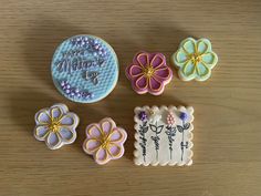 decorated cookies are sitting on a wooden table