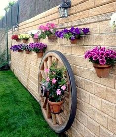 flowers are growing on the side of a brick wall