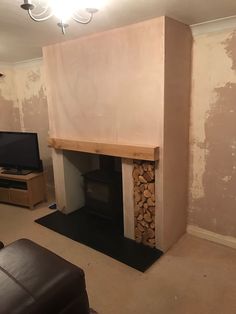 a living room with a fire place next to a tv