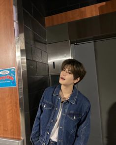 a young man standing in front of an elevator