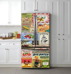 a refrigerator covered in magnets and food items next to a counter with white cabinets