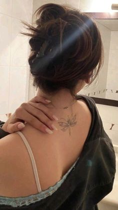 a woman with a tattoo on her back