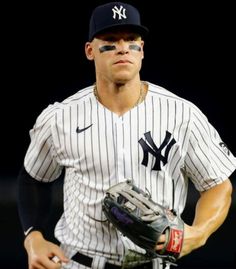 a baseball player wearing a new york yankees uniform