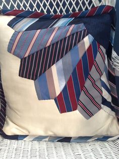 a pillow with ties on it sitting on a chair