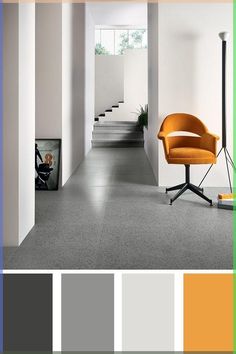 an orange chair sitting in the middle of a room with white walls and grey flooring