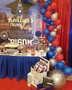 balloons and streamers decorate the backdrop for this graduation party dessert table at nathan's trunk